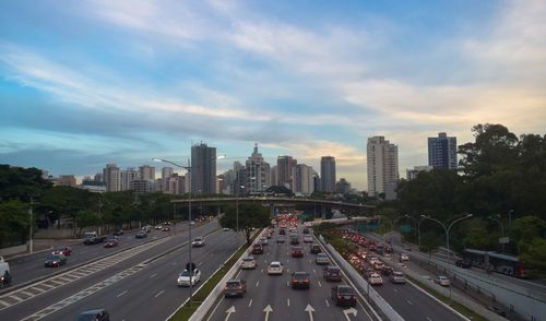 Traffic on road in city against sky