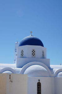 View of white church in santorini against blue sky
