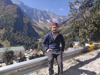 Full length portrait of young man against mountains