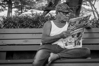 Full length of man sitting on bench