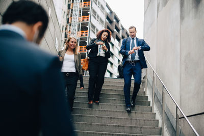 People standing on staircase in city