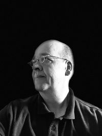 Portrait of man wearing hat against black background