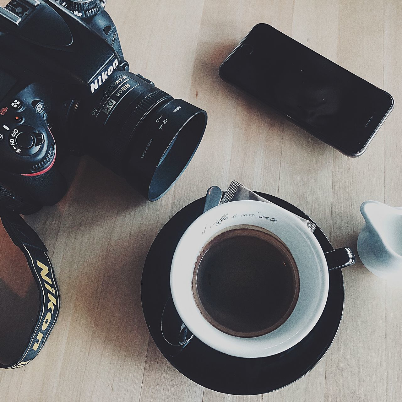 table, photography themes, technology, high angle view, indoors, still life, camera - photographic equipment, cup, mug, camera, drink, refreshment, food and drink, coffee, coffee cup, coffee - drink, no people, photographic equipment, saucer, digital camera, crockery, slr camera