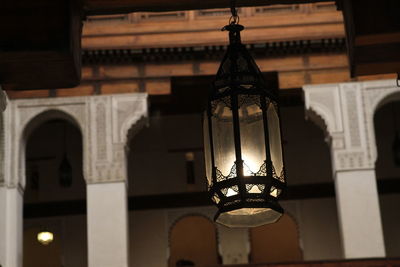 Low angle view of illuminated lamp in building