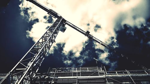 Low angle view of crane against sky