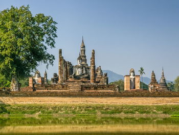 Trees on field against clear sky