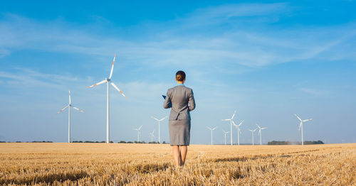 Man standing on field against sky