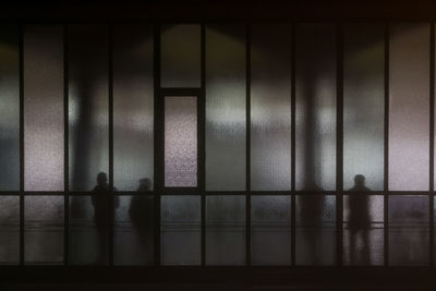 Shadow of people on glass window