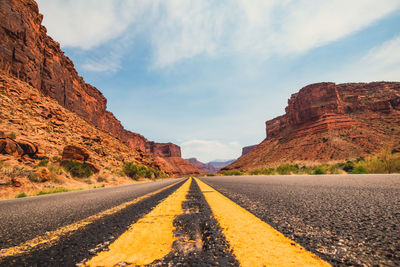 Surface level of road amidst rock formation against sky