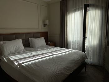 Rays of sun on a bed in a hotel