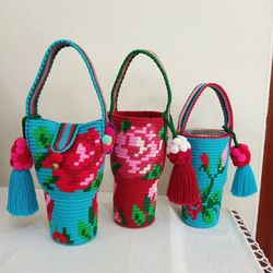 Close-up of multi colored wicker basket on table against wall