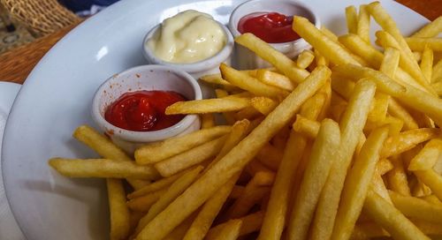 High angle view of french fries with sauce on tray