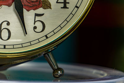 Close-up of clock on table