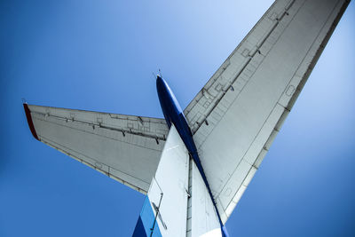 The tail of the plane against the blue sky close-up