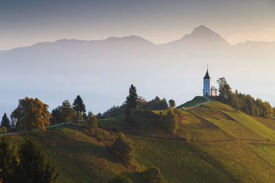 Scenic view of mountains and buildings against sky