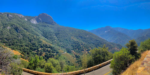 Scenic view of mountains against blue sky