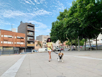 People walking with dog in city