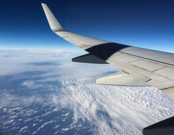 Aerial view of cloudscape over airplane wing