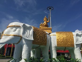 Low angle view of statue against temple against sky