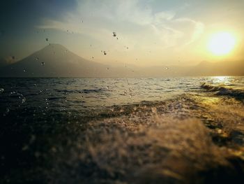 Scenic view of beach against sky during sunset