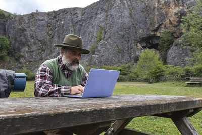 Young woman using laptop while sitting on table