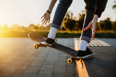 Low section of man skateboarding on street