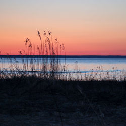 Scenic view of sea against romantic sky at sunset