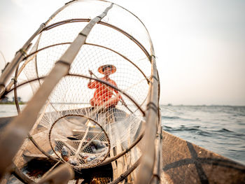 Close-up of fishing net against clear sky