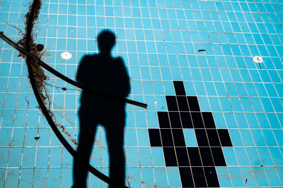 High angle view of man shadow against blue sky