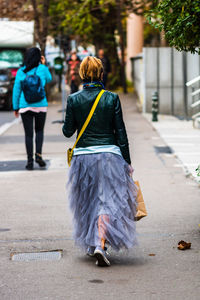 Rear view of women walking on street