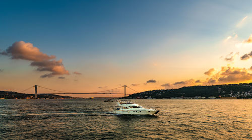 Sailboat on sea against sky during sunset