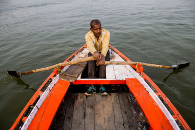 Portrait of man sitting on boat in sea