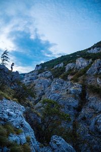 Scenic view of rocky mountains against cloudy sky