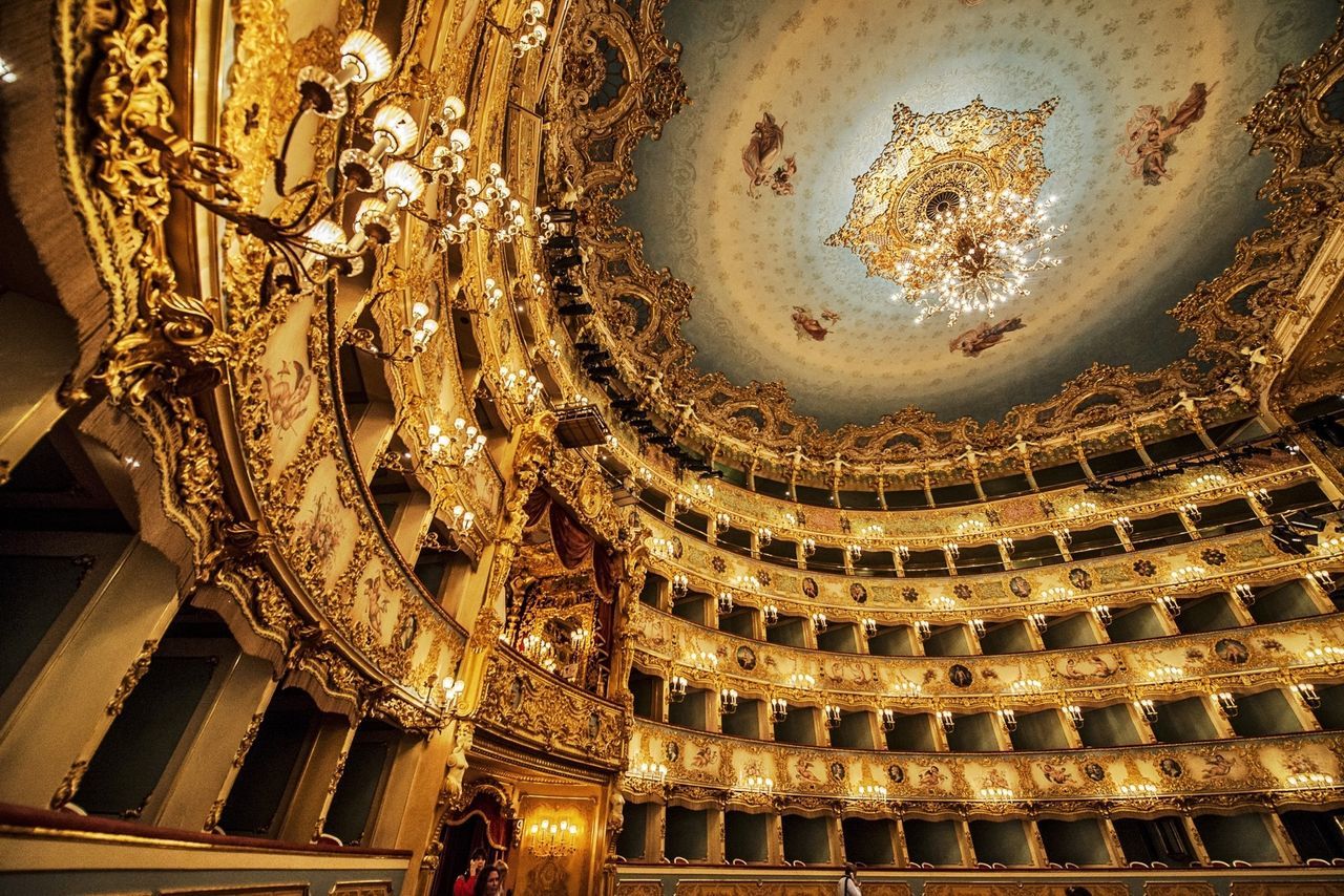 indoors, architecture, illuminated, built structure, low angle view, ceiling, place of worship, religion, ornate, history, lighting equipment, spirituality, famous place, decoration, building exterior, travel destinations, tourism, interior, architectural feature