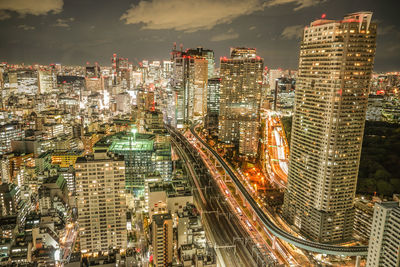 High angle view of illuminated cityscape against sky at night