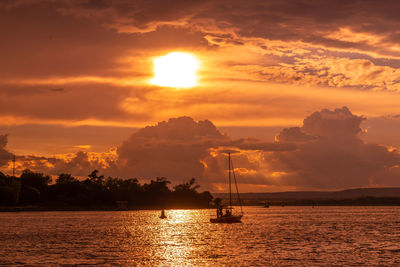 Boat in black sea at sunset