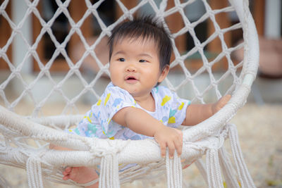 Portrait of cute girl sitting outdoors