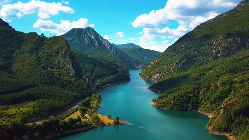 Scenic view of lake and mountains against sky