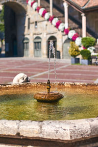 Close-up of fountain against building