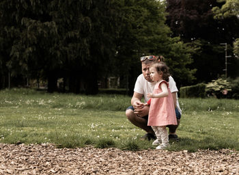 Portrait of a baby girl with her father in the park.