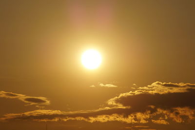 Low angle view of bright sun in sky