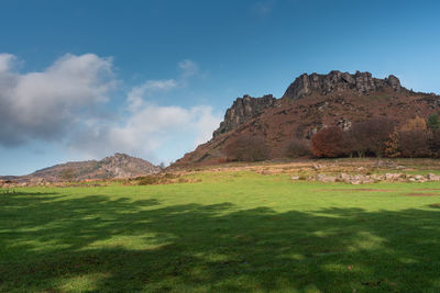 Scenic view of land and mountains against sky