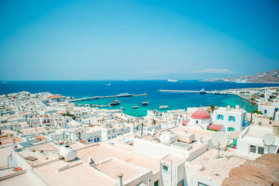 High angle view of townscape by sea against sky