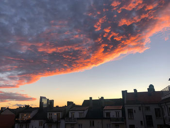 Low angle view of buildings against sky at sunset