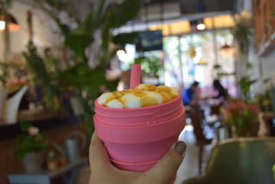 Close-up of hand holding ice cream