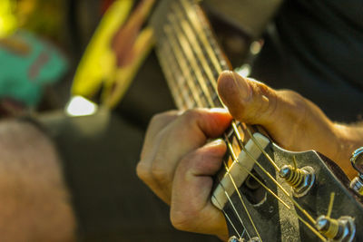 Close-up of man playing guitar