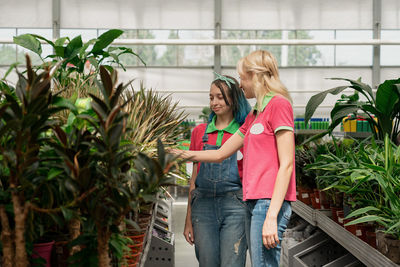 Portrait of woman standing against plants