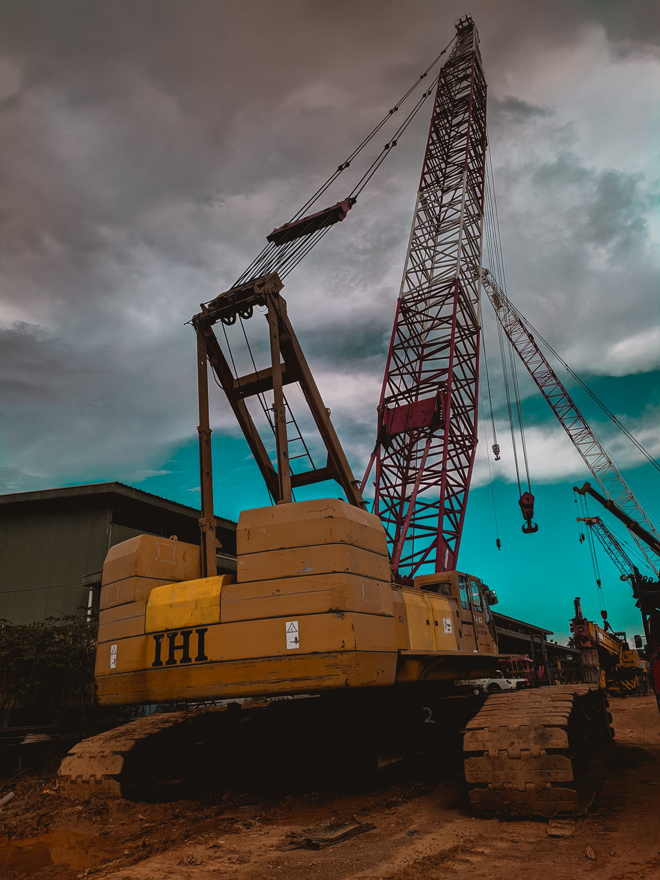 LOW ANGLE VIEW OF CRANE AGAINST SKY
