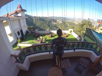 Rear view of woman on building terrace