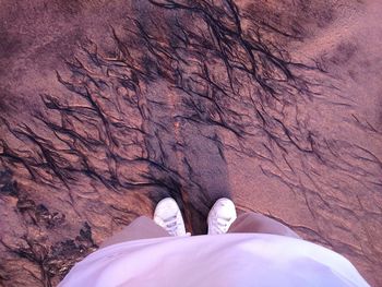 Low angle view of man standing at sandy beach